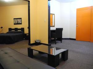 a living room with a couch and a mirror at Hotel San Sebastian in Bogotá