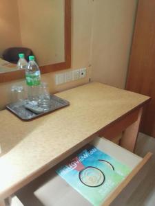 a table with a book and a bottle of water on it at Istana Monaco Hotel in Tawau