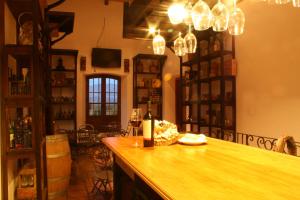 a bar with a bottle of wine on a counter at Altalaluna Hotel Boutique & Spa in Cafayate