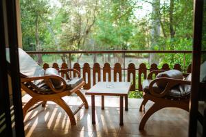 a porch with chairs and a table on a balcony at Vana Varin Resort in Hua Hin