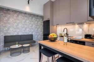 a kitchen with a table with a bowl of fruit on it at Orama Luxury Apartments in Nea Kydonia