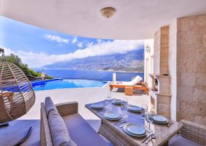 a dining room with a table and a view of the ocean at Villa Mavi Manzara in Kas