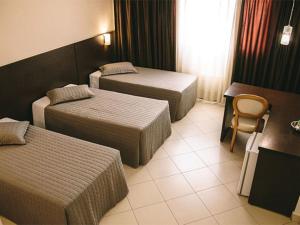 Postel nebo postele na pokoji v ubytování Hotel Dunamys Curitiba + 14 fotografií