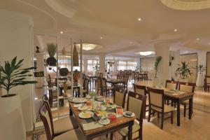 a dining room with tables and chairs in a restaurant at De Leopol Hotel in Addis Ababa