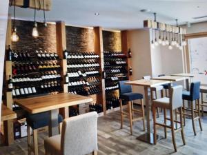 a wine tasting room with wooden tables and chairs at Superbe appartement Champex-Lac avec piscine et sauna in Champex