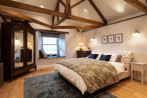 a bedroom with a large bed and a window at Trevidgeowe Farmhouse in Bodmin