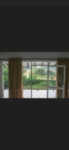 a view of a window with a view of a balcony at Pinnawala Elephant Front View Hotel in Rambukkana