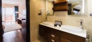 a bathroom with a sink and a toilet and a mirror at Savoy Le Grand Hotel Marrakech in Marrakech