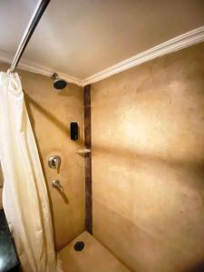 a corner of a bathroom with a shower stall at status business hotel in Kānpur