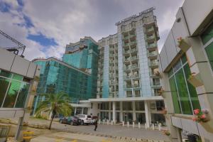 a tall building with cars parked in front of it at De Leopol Hotel in Addis Ababa
