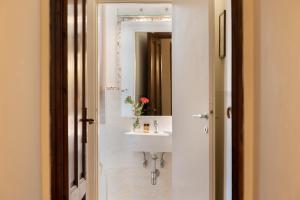 a bathroom with a sink and a mirror at Hotel Cimabue in Florence +66 photos