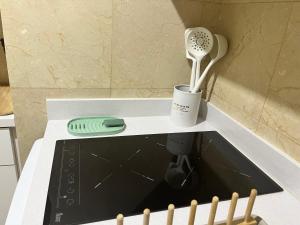 a kitchen counter with a hair dryer and a whisk at Precioso y tranquilo apartamento zona alta Diagonal Barcelona in Barcelona +15 photos