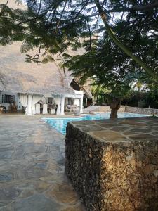 a resort with a swimming pool and a building at Fulvia House in Malindi