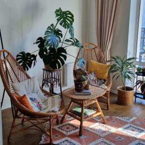 a room with two chairs and a table and plants at Kyiv Jungle apartment in Kyiv