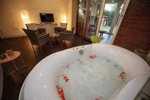 a bath tub filled with blood in a living room at Hilltop Wellness Villa-big garden, sauna, hot tube in Pécs