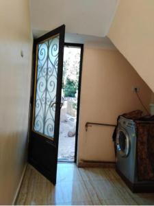 a door to a laundry room with a washing machine at NUBA ONe in Aswan