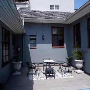 a patio with a table and chairs in front of a building at The City Club in Cape Town +202 photos