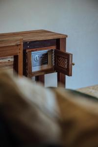 a wooden table with a clock on top of it at Vedya Boutique Hostel in General Luna
