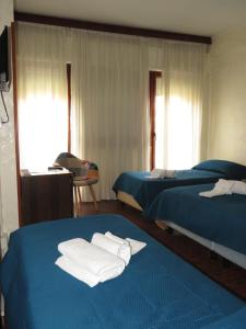 a hotel room with two beds with towels on them at Hotel San Michele in Aprilia