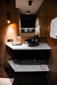 a bathroom with a sink and a bowl on a counter at MaLux Nis in Niš