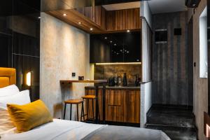 a hotel room with a bed and a bar at MaLux Nis in Niš