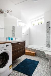 a white bathroom with a washing machine in it at Cecile's Central, Gastro str, WIFI, 2 bed and 2 bathrooms in Budapest