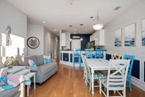 a living room and kitchen with a couch and a table at Salty Girl in Oak Island