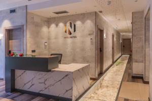 a lobby of a hotel with a reception desk at Hotel NERU con Encanto in León