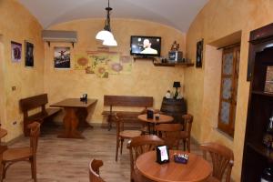 un restaurante con mesas y sillas y TV en la pared en B&B LE DUE ISOLE en Nuoro