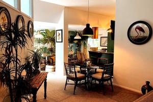 a dining room with a table and chairs in a room at Palm View Luxury Botanical Themed apartment with sauna in St Austell