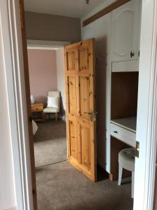 a room with a wooden door and a desk at Kielty's of Kerry Bed and Breakfast in Waterville