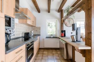 a kitchen with wooden cabinets and a counter top at Haus Felsberg in Niedersalwey
