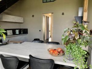 a table with chairs and a bowl of food on it at La grange de thoricourt in Thoricourt