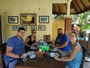 a group of people sitting around a table at Depotrek Villas in Amed