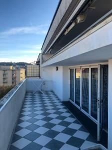 a balcony with a black and white checkered floor at Sestri AR122 Executive Penthouse in Sestri Levante