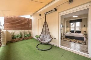 a room with a hammock and a bedroom at Petralona Stylish Penthouse in Athens