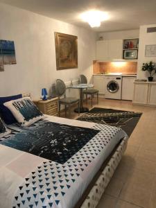 Un dormitorio con una cama grande y una cocina. en Monaco à 300m du Casino - Grand Studio avec Piscine, en Beausoleil 16 fotos más