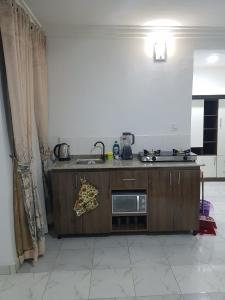 a kitchen with a sink and a counter top at Andrea’s Home in Abuja