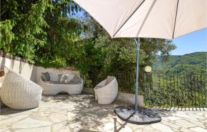 a patio with an umbrella and chairs and a couch at Gorgeous Apartment In Carcheto Brustico in Carcheto +6 photos