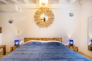 a bedroom with a blue bed and a mirror at Ca' Del Jago Sole Luna apartment in Negrar
