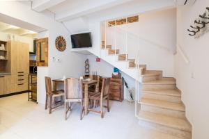 a kitchen and dining room with a staircase and a table and chairs at Ca' Del Jago Sole Luna apartment in Negrar