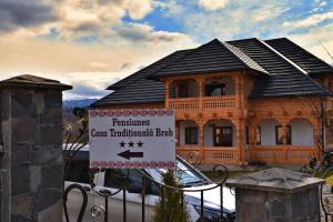 a house with a sign in front of it at Casa Traditionala Breb in Breb