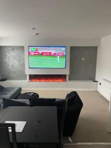 a living room with a tv and a fire place at 03 Glasgow Flat in Glasgow