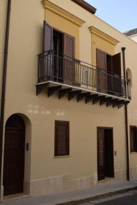 a building with two balconies on the side of it at Le Gemme in Castellammare del Golfo