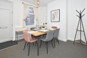 a dining room with a table and chairs at Lowther House by YourStays in Stoke on Trent