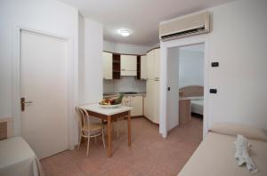 パルゲリーアにあるIl Poggio Di Tropeaのテーブルとベッドが備わる小さなアパートメントです。