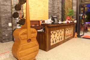 東港的住宿－綠芳水岸民宿，坐在商店前的木吉他