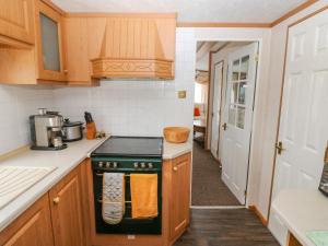 a kitchen with a stove top oven next to a hallway at Park Lane in Narberth