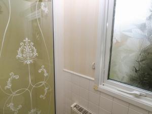 a shower curtain in a bathroom with a window at Park Lane in Narberth +16 photos