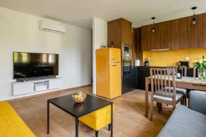 a kitchen and living room with a yellow refrigerator at The Best Location in Cracow for City Break in Kraków
